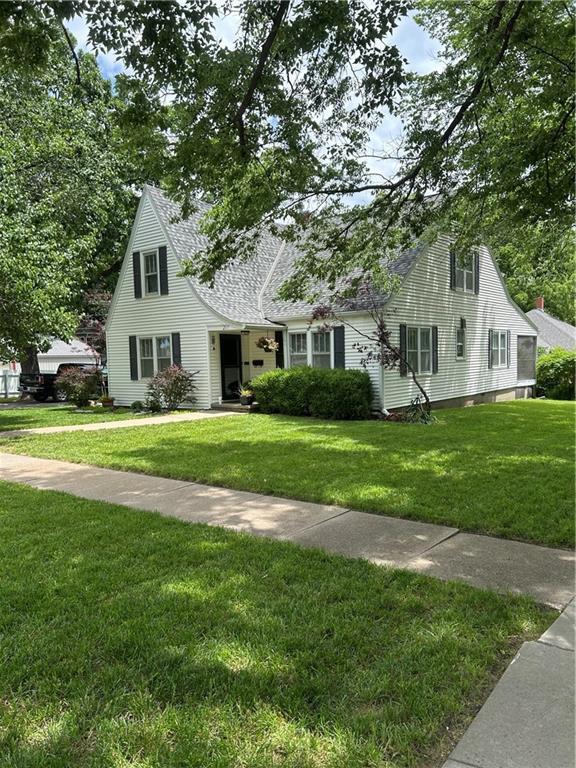 217 S 5th St, Burlington, KS 66839 - cape cod-style house with a front yard and a shingled roof