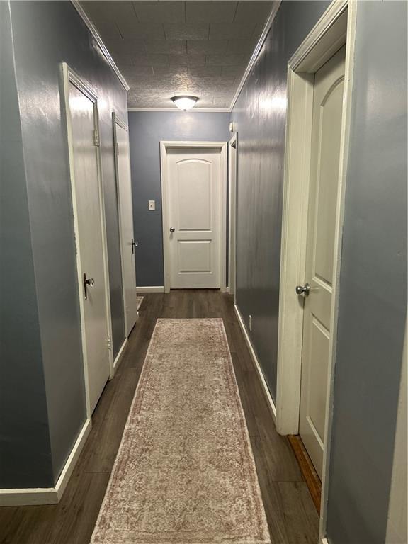 217 S 5th St, Burlington, KS 66839 - corridor featuring dark wood-type flooring and crown molding