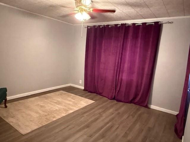 217 S 5th St, Burlington, KS 66839 - unfurnished room featuring ceiling fan, dark wood-style floors, and ornamental molding