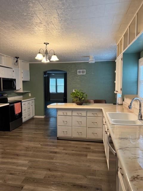 217 S 5th St, Burlington, KS 66839 - kitchen with stainless steel appliances, a peninsula, plenty of natural light, and a chandelier