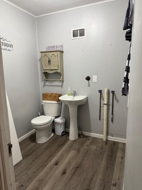 217 S 5th St, Burlington, KS 66839 - half bathroom with wood finished floors and toilet