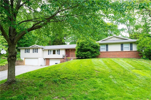 2002 N 29th St, Saint Joseph, MO 64506 - view of front of home with brick siding, a garage, driveway, and a front yard