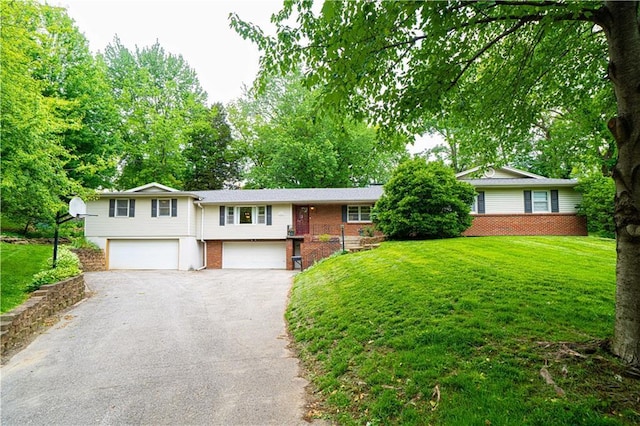 2002 N 29th St, Saint Joseph, MO 64506 - view of front facade featuring brick siding, an attached garage, driveway, and a front yard