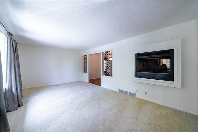2002 N 29th St, Saint Joseph, MO 64506 - empty room featuring carpet, baseboards, and a fireplace