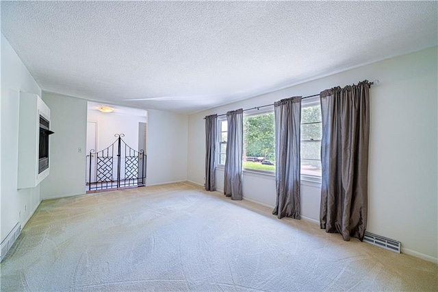 2002 N 29th St, Saint Joseph, MO 64506 - spare room featuring light carpet, a textured ceiling, and baseboards