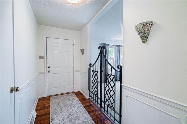 2002 N 29th St, Saint Joseph, MO 64506 - entryway with dark wood-style floors, wainscoting, and a textured ceiling