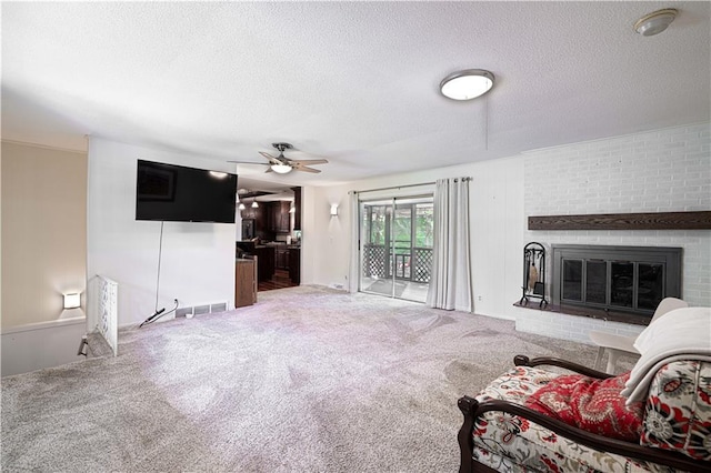 2002 N 29th St, Saint Joseph, MO 64506 - living area with a textured ceiling, carpet, ceiling fan, and a brick fireplace