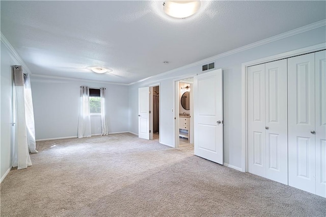2002 N 29th St, Saint Joseph, MO 64506 - unfurnished bedroom with light colored carpet, crown molding, a closet, baseboards, and a textured ceiling