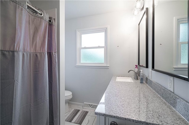 2002 N 29th St, Saint Joseph, MO 64506 - full bathroom featuring toilet, vanity, and baseboards