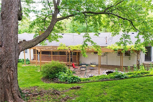 2002 N 29th St, Saint Joseph, MO 64506 - rear view of property featuring roof with shingles, a yard, and a patio area