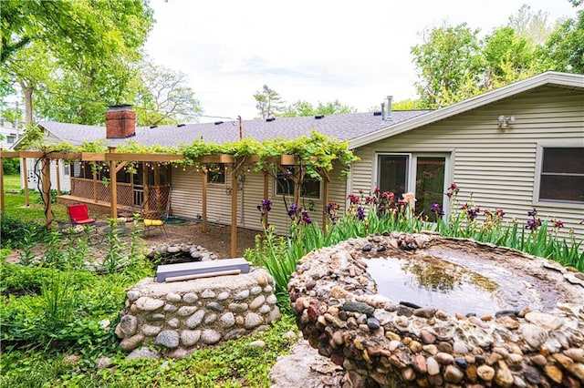 2002 N 29th St, Saint Joseph, MO 64506 - rear view of house with a chimney and a shingled roof