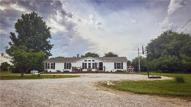 69 Porcupine Path, Linn Valley, KS 66040 - view of front of house with a deck, a front yard, and gravel driveway