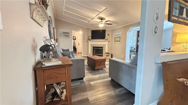 69 Porcupine Path, Linn Valley, KS 66040 - living room with ceiling fan, wood finished floors, a tiled fireplace, and ornamental molding