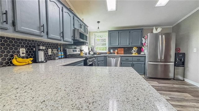 69 Porcupine Path, Linn Valley, KS 66040 - kitchen featuring appliances with stainless steel finishes, ornamental molding, decorative backsplash, light countertops, and wood finished floors