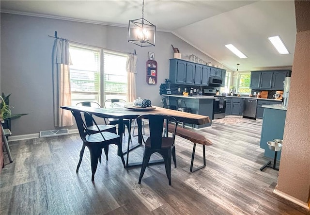 69 Porcupine Path, Linn Valley, KS 66040 - dining space featuring dark wood-type flooring, lofted ceiling, a chandelier, and baseboards