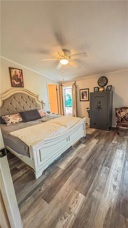 69 Porcupine Path, Linn Valley, KS 66040 - bedroom with crown molding, wood finished floors, and a ceiling fan