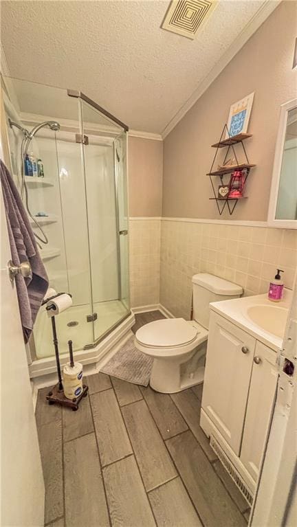 69 Porcupine Path, Linn Valley, KS 66040 - bathroom with vanity, a stall shower, a textured ceiling, toilet, and wood finished floors