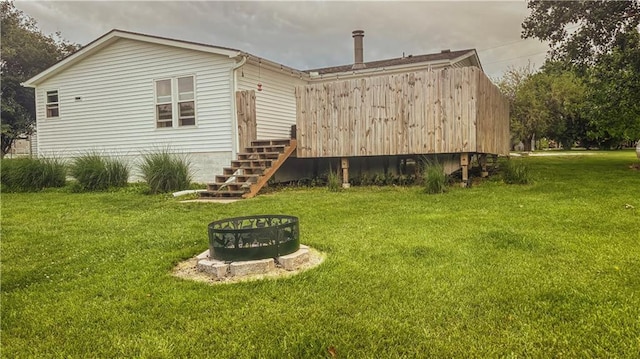 69 Porcupine Path, Linn Valley, KS 66040 - back of house featuring an outdoor fire pit, a yard, stairs, and a deck