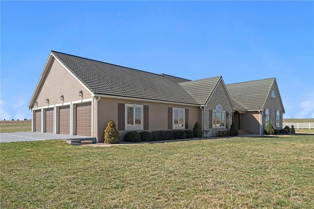 14971 Fairmount Rd, Basehor, KS 66007 - view of front of house with a front yard, stucco siding, concrete driveway, and a tile roof