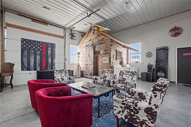 14971 Fairmount Rd, Basehor, KS 66007 - living area with concrete floors and washing machine and clothes dryer
