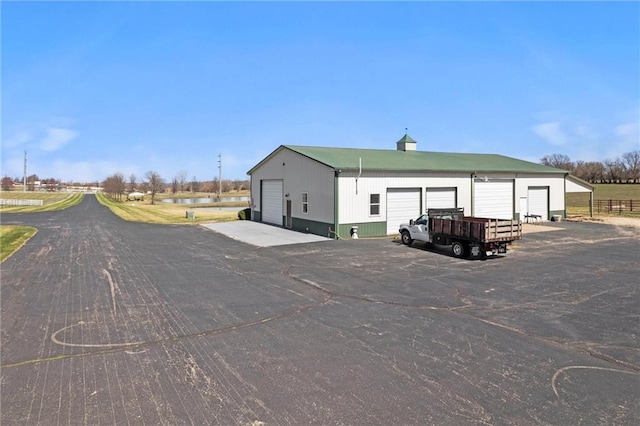 14971 Fairmount Rd, Basehor, KS 66007 - view of side of home featuring a garage and an outbuilding