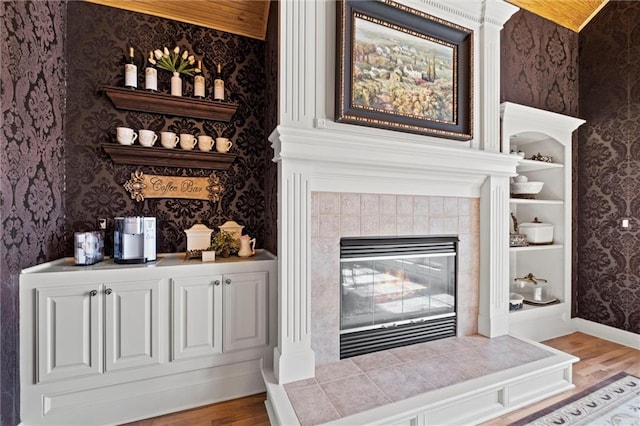 14971 Fairmount Rd, Basehor, KS 66007 - detailed view of wallpapered walls, wood finished floors, baseboards, and a tile fireplace