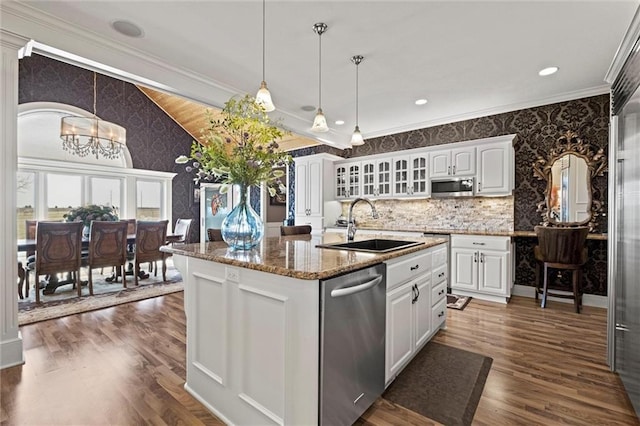 14971 Fairmount Rd, Basehor, KS 66007 - kitchen with stainless steel appliances, wallpapered walls, a chandelier, a sink, and glass insert cabinets