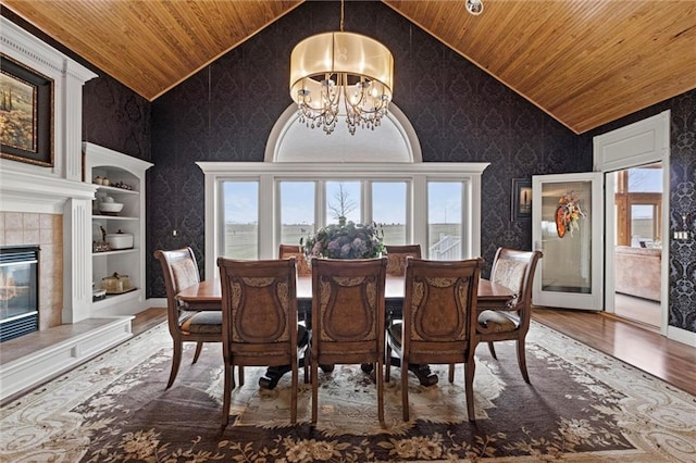 14971 Fairmount Rd, Basehor, KS 66007 - dining room with wood ceiling, lofted ceiling, wood finished floors, wallpapered walls, and a chandelier