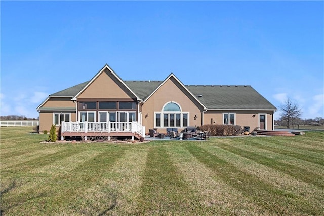 14971 Fairmount Rd, Basehor, KS 66007 - back of property with a yard, stucco siding, and a sunroom