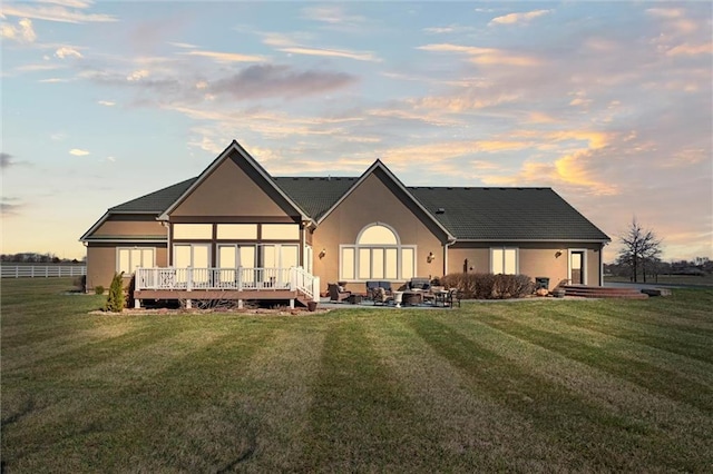 14971 Fairmount Rd, Basehor, KS 66007 - back of property featuring a lawn, an outdoor living space, and stucco siding