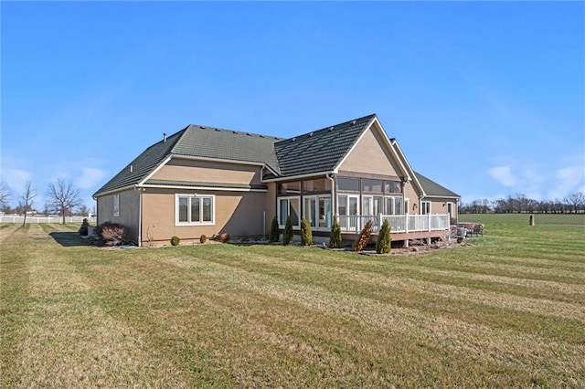 14971 Fairmount Rd, Basehor, KS 66007 - back of property with a sunroom, a lawn, and stucco siding