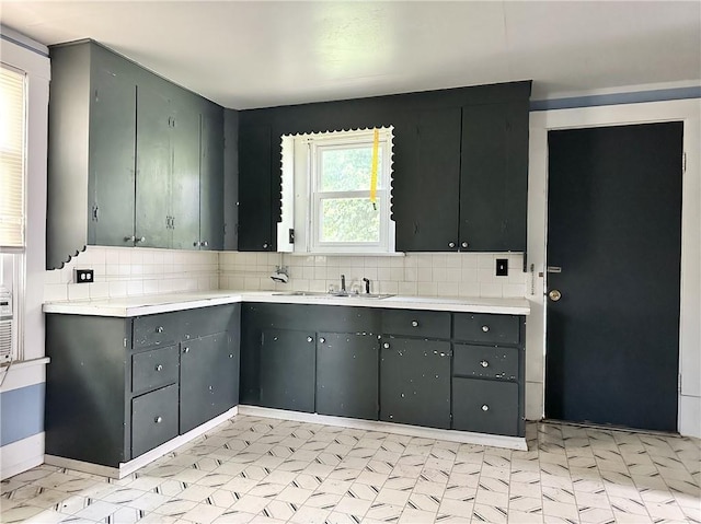 206 S Main St, Trenton, MO 64683 - kitchen with a sink, gray cabinetry, backsplash, light countertops, and light flooring