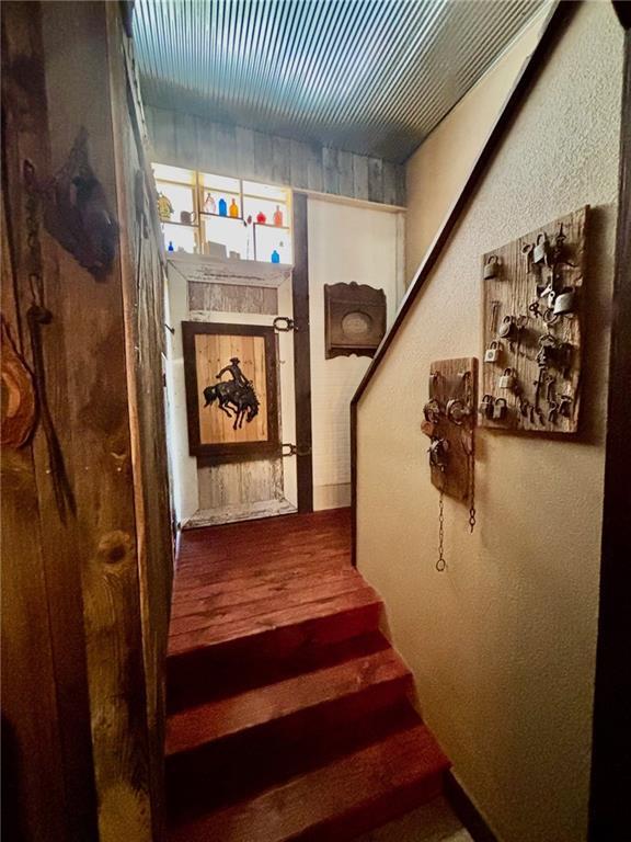 115 N 3rd St, Burlington, KS 66839 - staircase with wood finished floors and baseboards