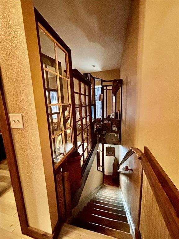 115 N 3rd St, Burlington, KS 66839 - staircase with a textured wall and wood finished floors