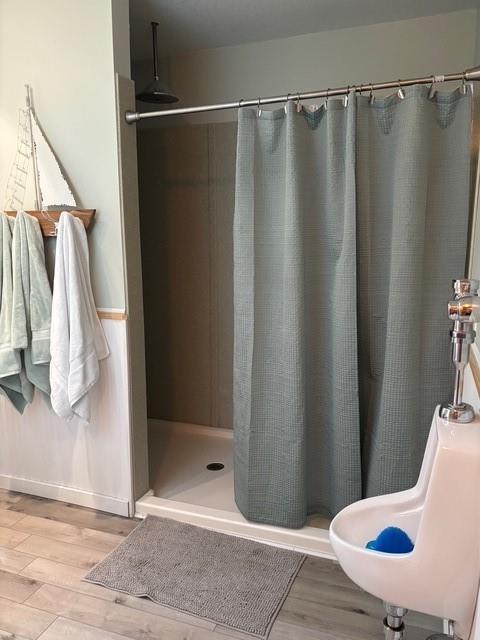115 N 3rd St, Burlington, KS 66839 - bathroom with wood finished floors, a stall shower, and baseboards