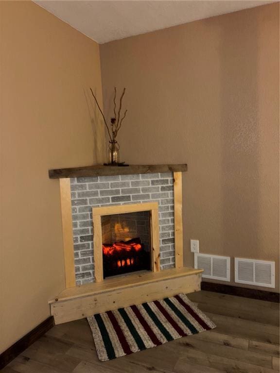 115 N 3rd St, Burlington, KS 66839 - detailed view of a fireplace, wood finished floors, and baseboards