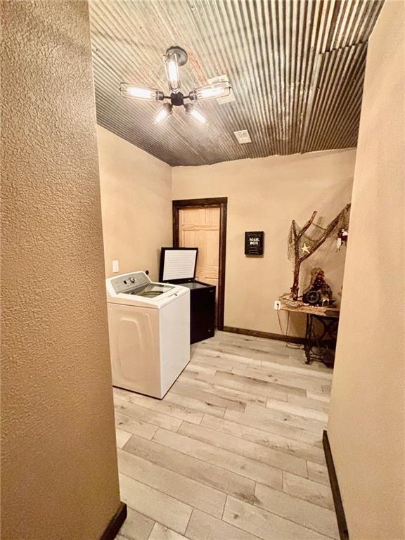 115 N 3rd St, Burlington, KS 66839 - washroom with washer / dryer, light wood finished floors, and baseboards