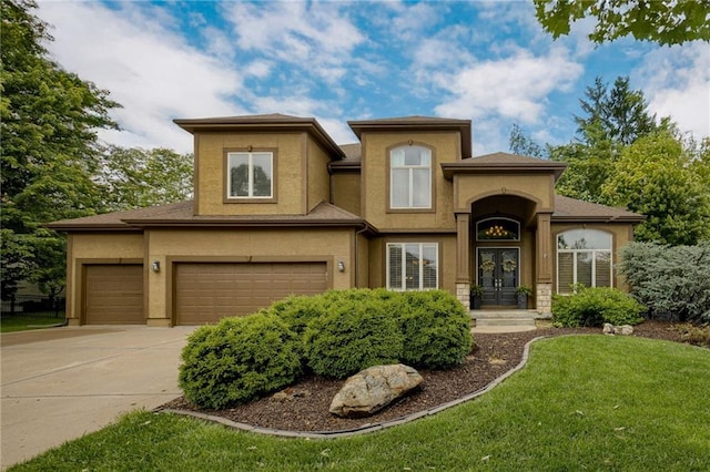 5204 W 166th St, Overland Park, KS 66085 - view of front facade featuring a front yard, concrete driveway, stucco siding, and a garage
