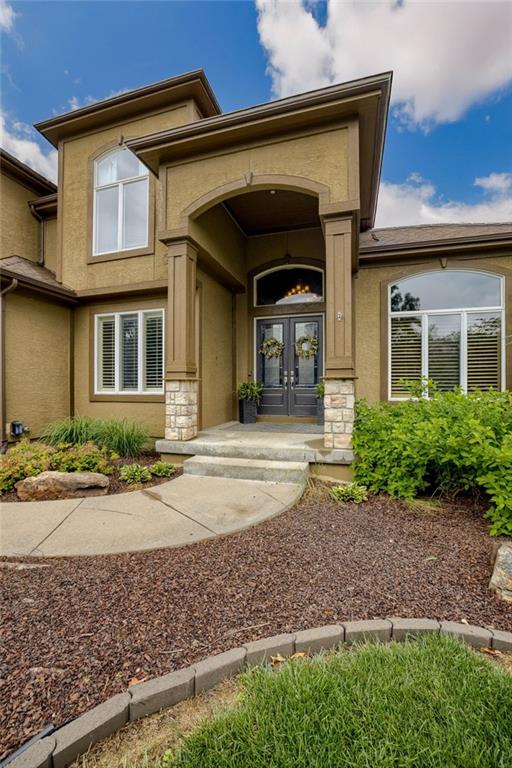 5204 W 166th St, Overland Park, KS 66085 - view of exterior entry featuring stone siding, french doors, and stucco siding