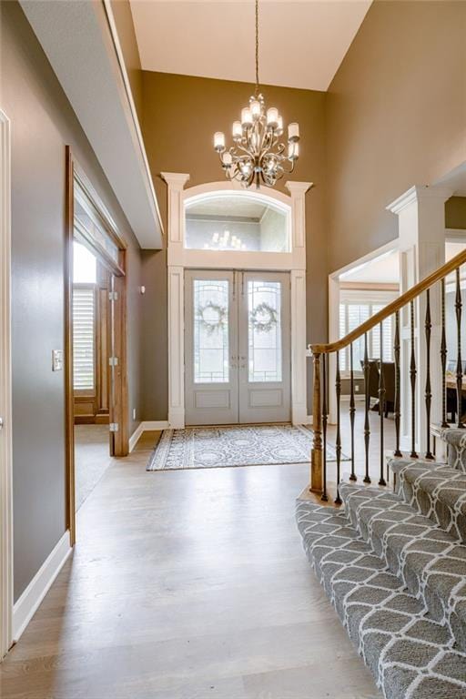 5204 W 166th St, Overland Park, KS 66085 - foyer entrance with a high ceiling, wood finished floors, a chandelier, baseboards, and stairway