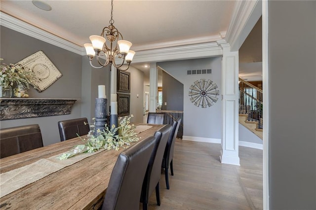 5204 W 166th St, Overland Park, KS 66085 - dining space with a chandelier, stairs, ornamental molding, wood finished floors, and baseboards