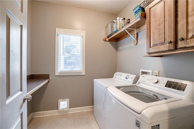 5204 W 166th St, Overland Park, KS 66085 - laundry area with washing machine and dryer, cabinet space, baseboards, and light tile patterned floors