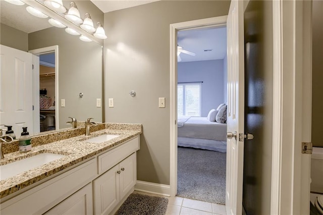 5204 W 166th St, Overland Park, KS 66085 - full bathroom with connected bathroom, double vanity, tile patterned flooring, and baseboards