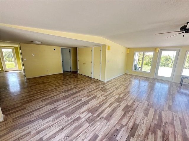 17795 K Hwy, Saint Joseph, MO 64505 - unfurnished living room with wood finished floors, ceiling fan, baseboards, and vaulted ceiling