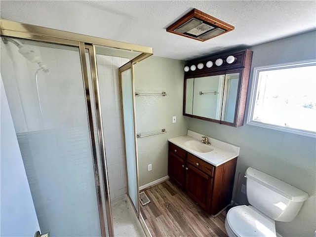 17795 K Hwy, Saint Joseph, MO 64505 - bathroom featuring vanity, a shower stall, toilet, wood finished floors, and a textured ceiling