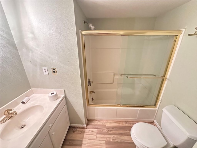 17795 K Hwy, Saint Joseph, MO 64505 - full bath with toilet, wood finished floors, shower / bath combination with glass door, a textured wall, and vanity