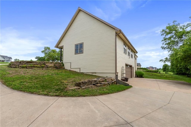 15405 161st St, Bonner Springs, KS 66012 - view of side of property with concrete driveway, an attached garage, and a yard