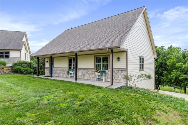 15405 161st St, Bonner Springs, KS 66012 - rear view of house featuring a lawn, a shingled roof, and stone siding