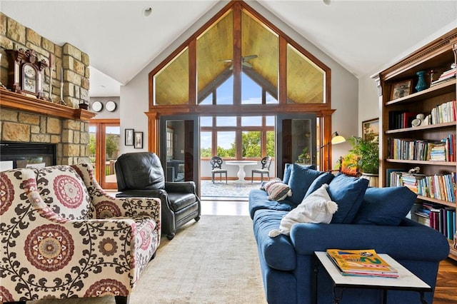 15405 161st St, Bonner Springs, KS 66012 - living room featuring healthy amount of natural light, high vaulted ceiling, a fireplace, and wood finished floors
