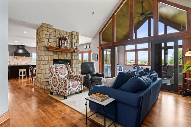15405 161st St, Bonner Springs, KS 66012 - living area featuring wood finished floors, a fireplace, ceiling fan, and high vaulted ceiling